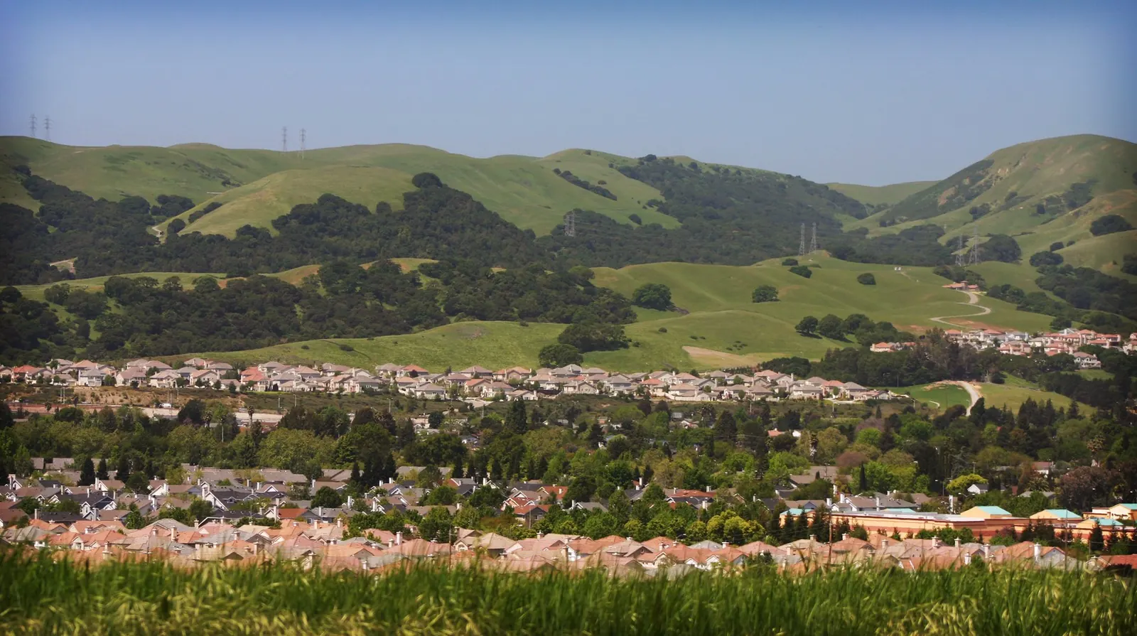 a view of a mountain range with trees and hills in the background